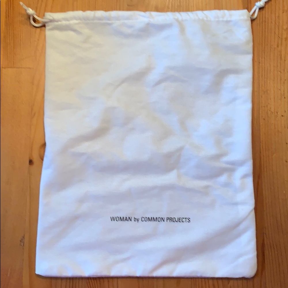 Woman by Common Projects dust bag